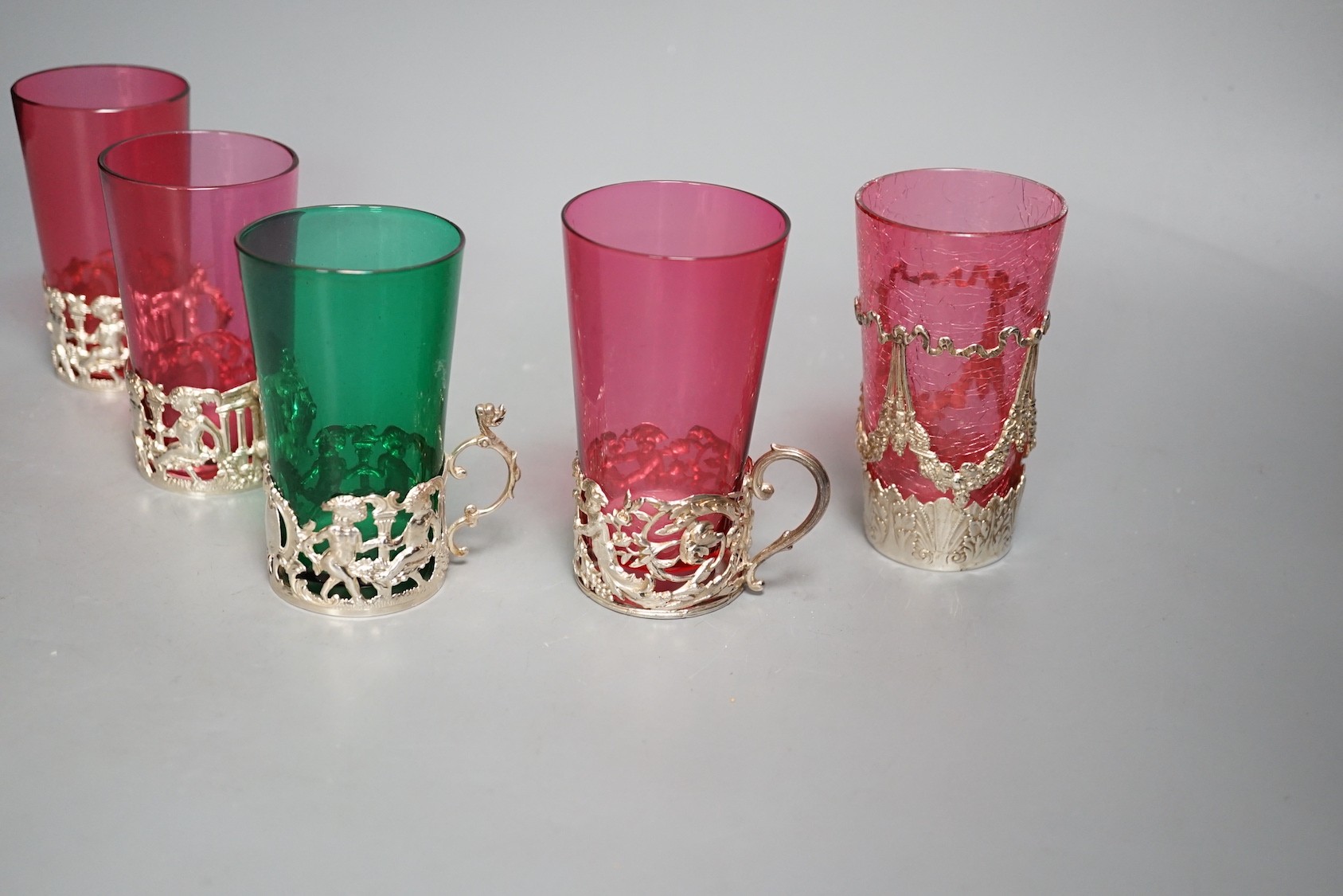 Five silver mounted glass tea holders - 9.5cm tall